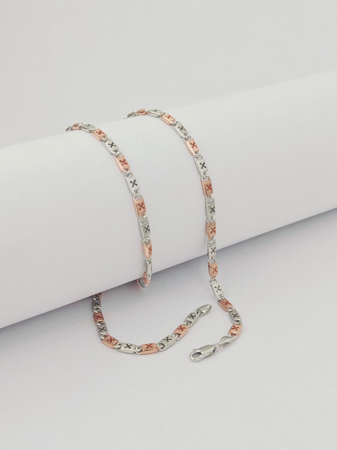Silver chain  on a light gray surface