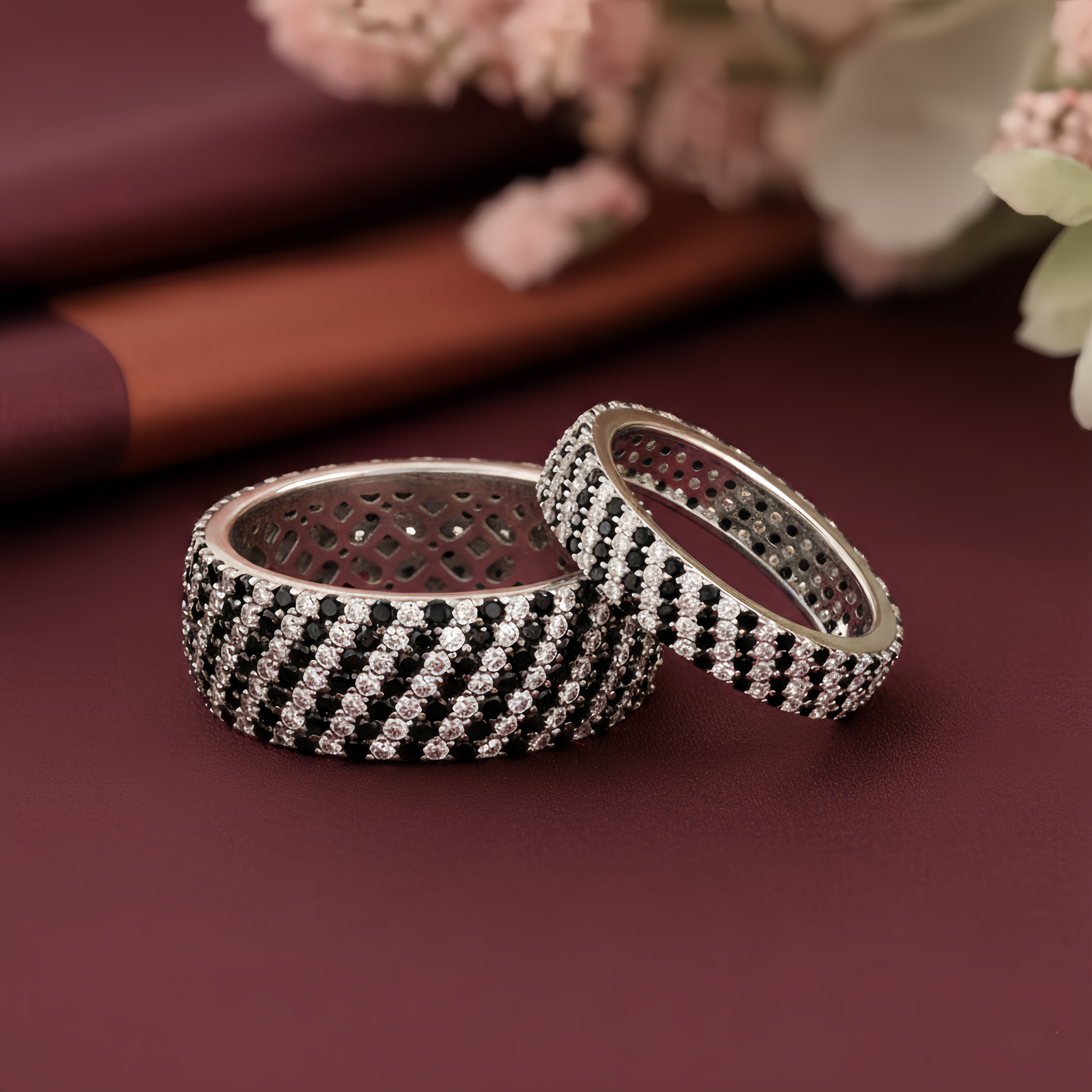 Sterling silver couple rings by Kivara Jewels, close-up of intertwined rings with smooth polished finish.