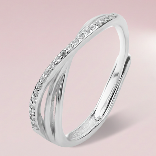 Silver ring with small diamonds on a pink background