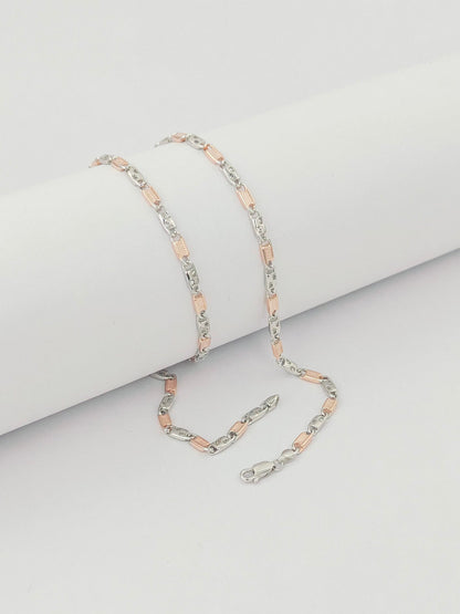 Two silver and rose gold chain  on a light gray background by kivara jewels